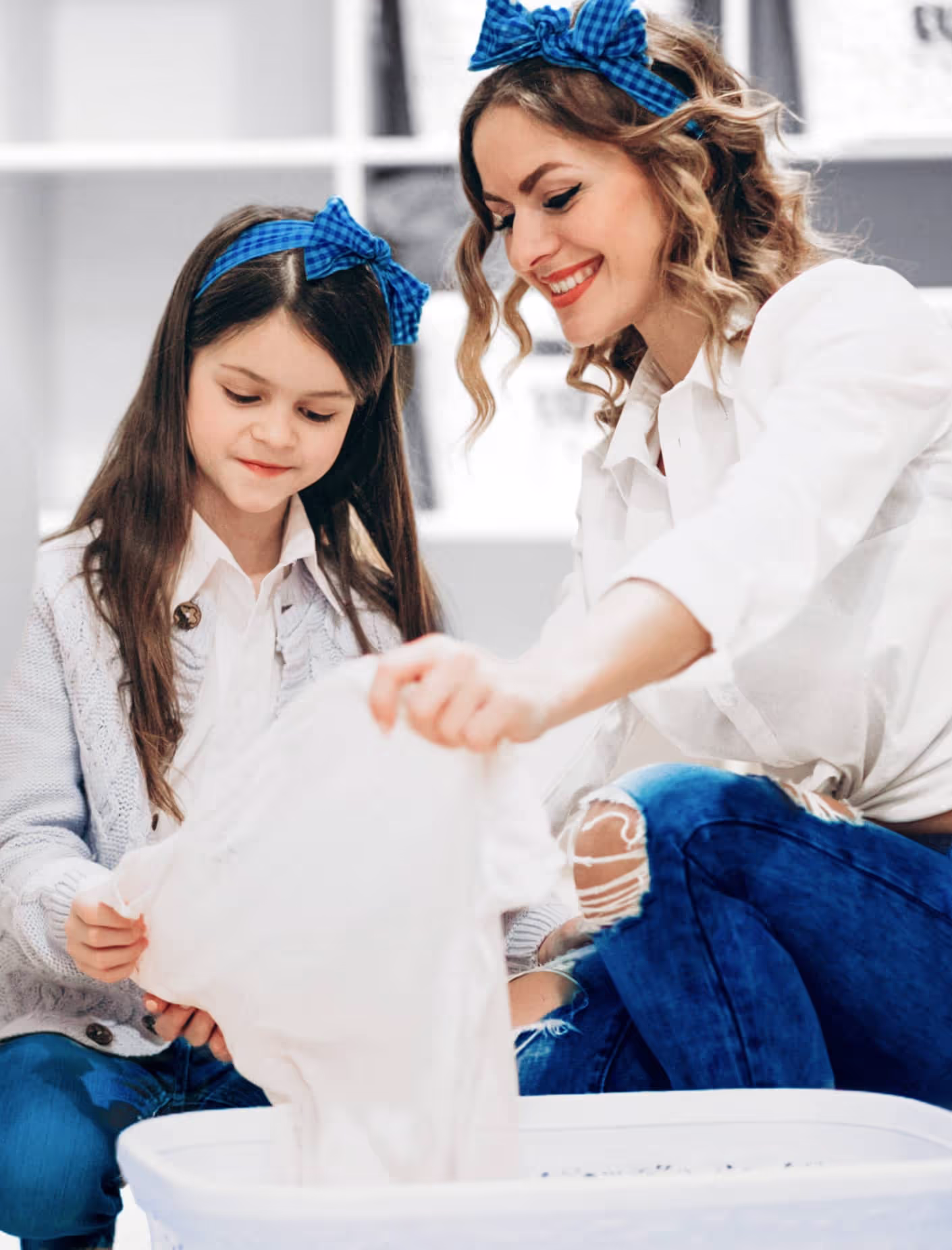 Mother and daughter with a basket of clean laundry