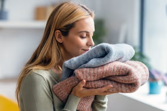 Freshly dry cleaned clothes on hangers