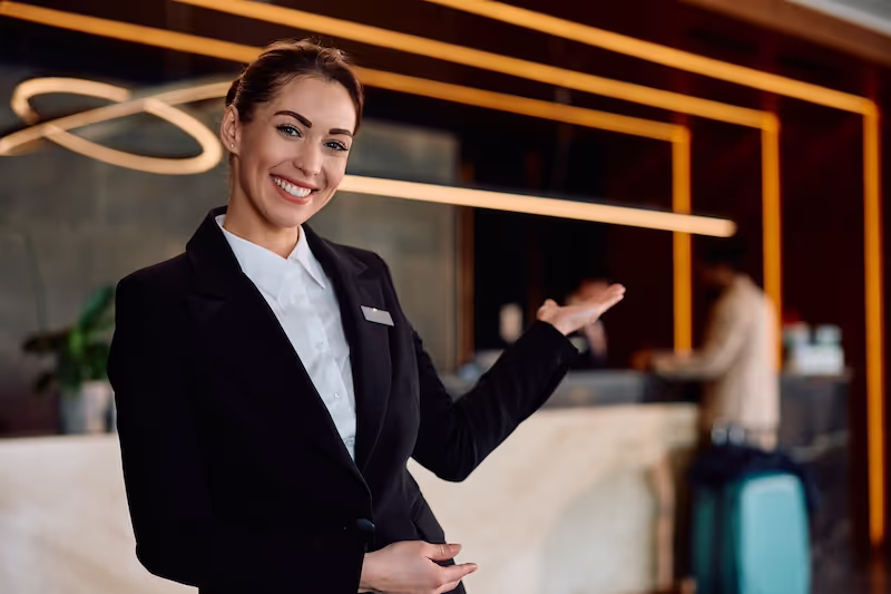 Hotel receptionist welcoming guests at the front desk